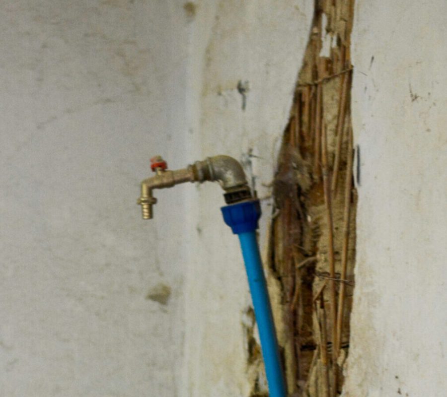 Picture of damaged pipe coming out of a wall