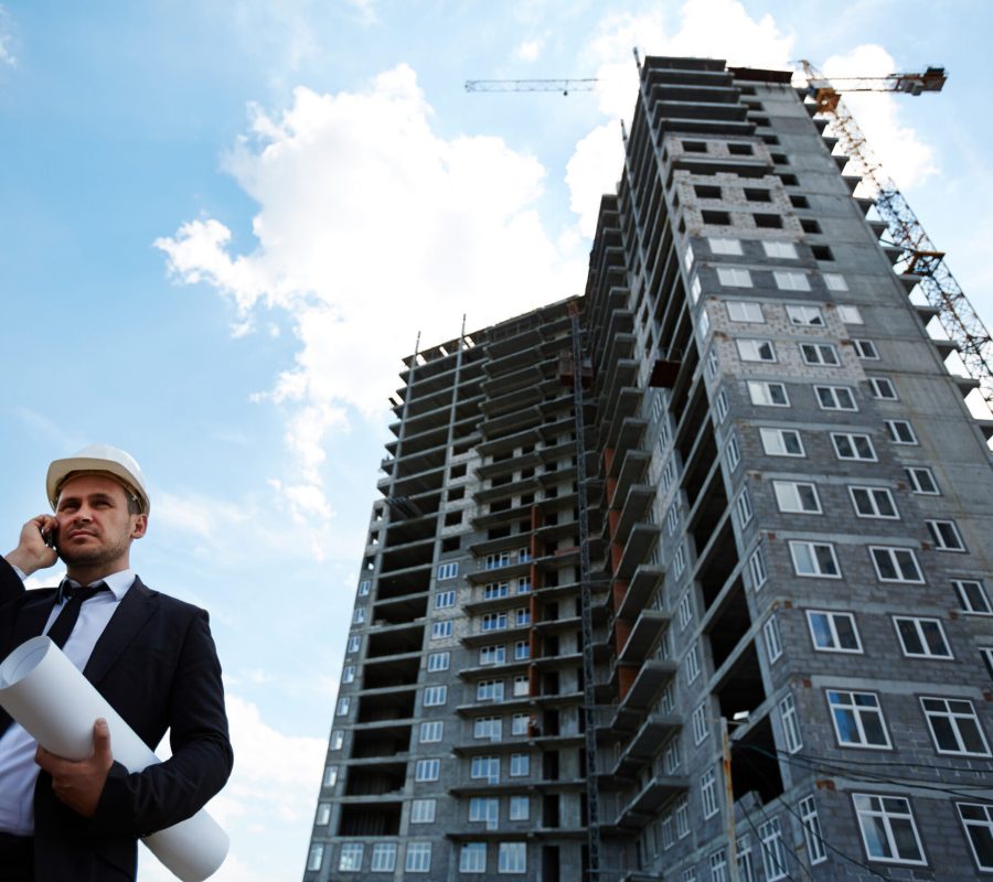 picture of property manager talking on phone to manage the building with background of a condo